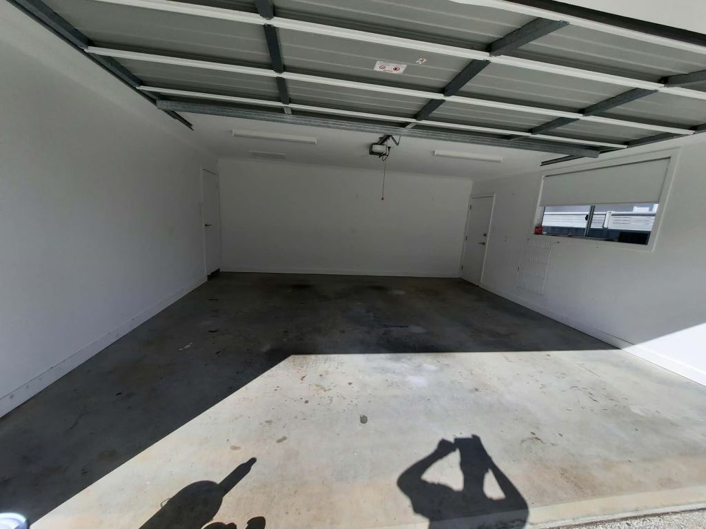 Bare, stained concrete garage slab before coating