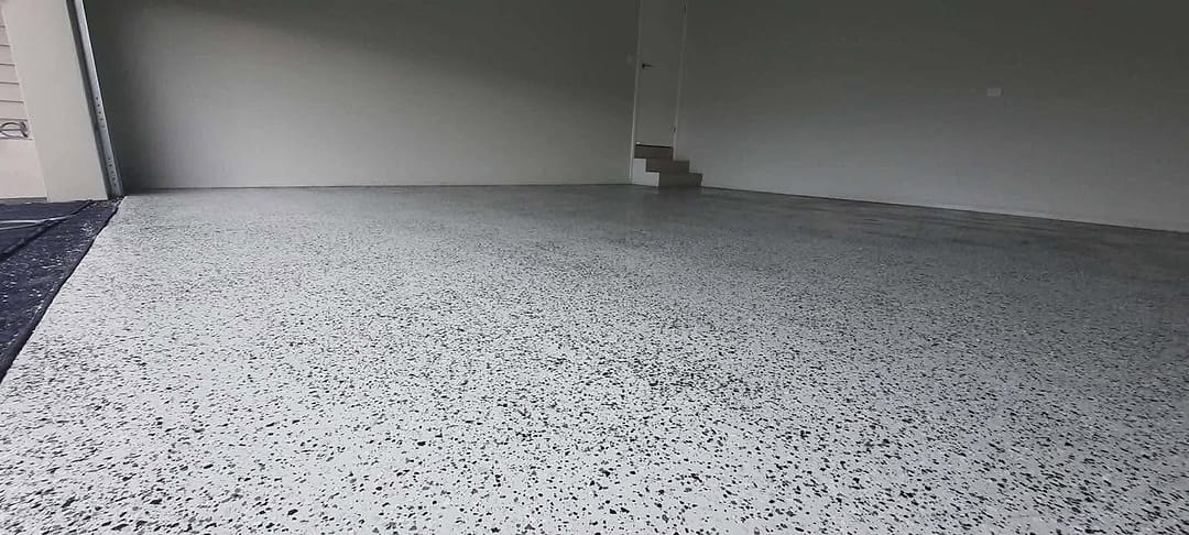 Finished flake epoxy garage floor with grey and charcoal flake