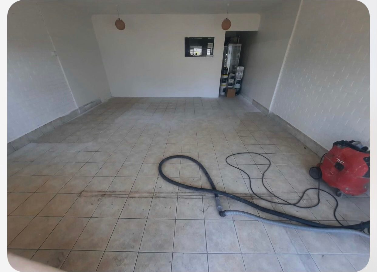 Old tiled floor before work started, dust extractor in shot