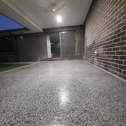 Flake epoxy floor finished up to a face brick wall